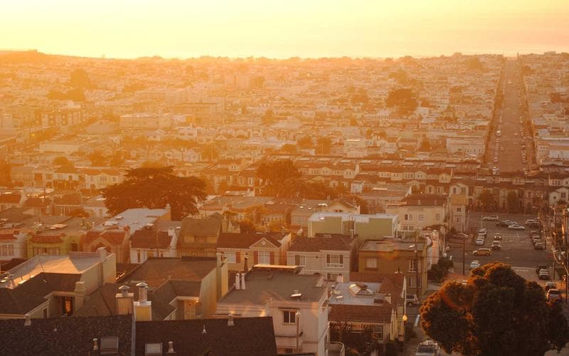 A close-up shot of a mixing console with faders and knobs.